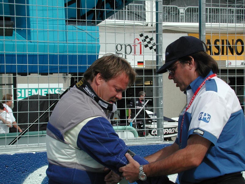 Steve Lorentzen adjusting arm restraints on pre grid.jpg 113.5K